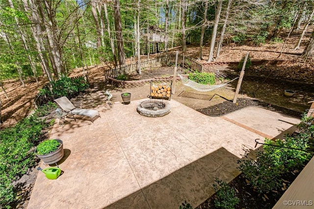 view of patio with a fire pit and fence
