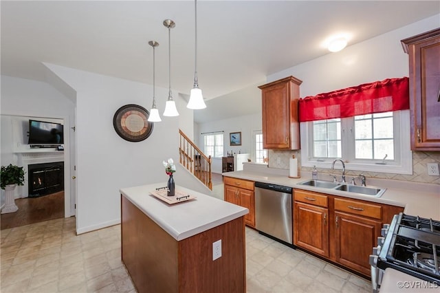 kitchen with stainless steel dishwasher, a sink, light floors, light countertops, and gas range oven