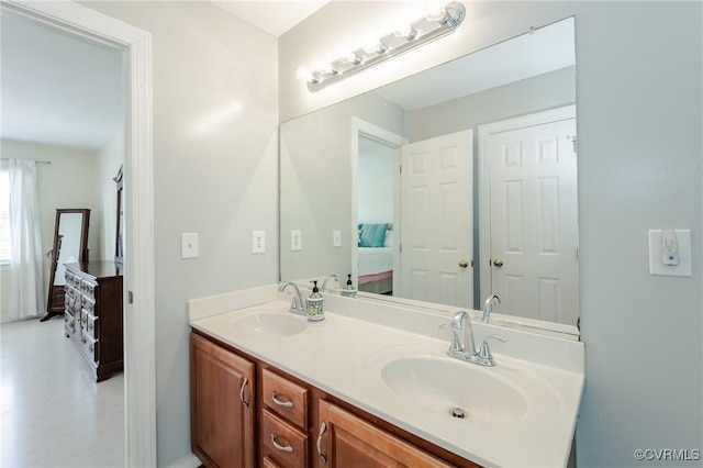 bathroom with ensuite bath, a sink, and double vanity