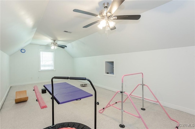 workout area featuring lofted ceiling, visible vents, a ceiling fan, and baseboards