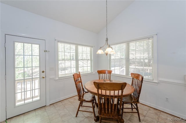 dining space with light floors, baseboards, high vaulted ceiling, and a notable chandelier