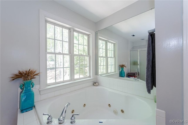 bathroom with a whirlpool tub and a shower