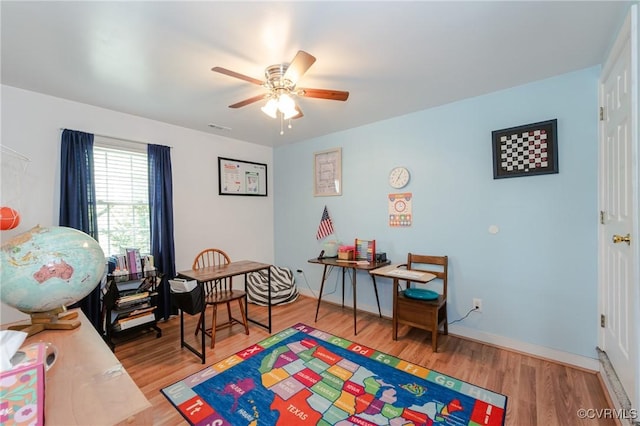 rec room with light wood finished floors and ceiling fan