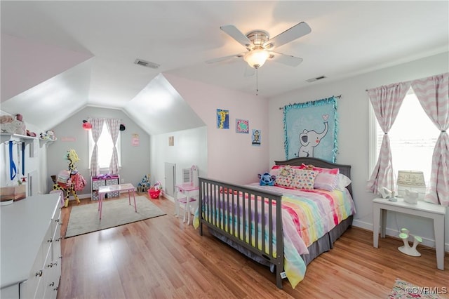bedroom with lofted ceiling, light wood-style flooring, visible vents, and a ceiling fan