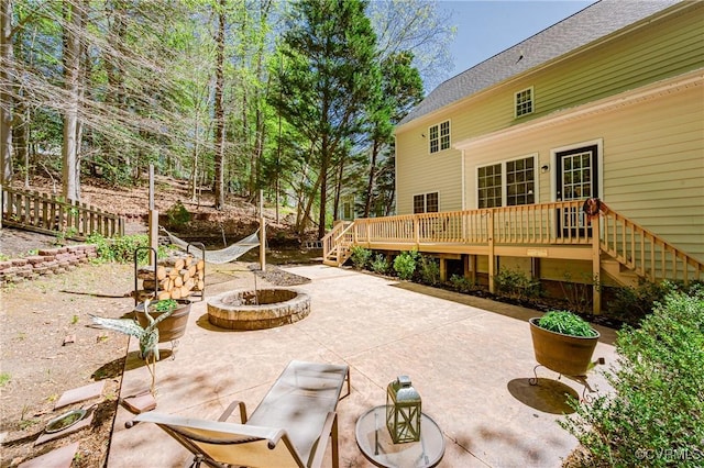view of patio featuring a wooden deck, stairs, and an outdoor fire pit