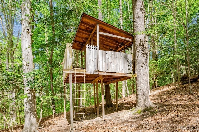 view of outbuilding with a forest view