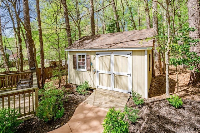 view of shed featuring fence