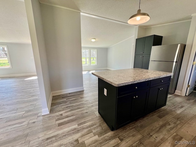 409 Remo Rd, Heathsville, VA 22473 - kitchen with crown molding, light countertops, freestanding refrigerator, open floor plan, and light wood-style flooring