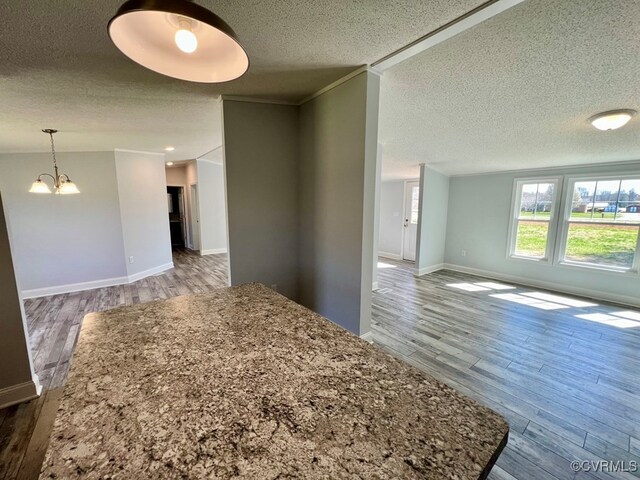 409 Remo Rd, Heathsville, VA 22473 - spare room with crown molding, wood finished floors, a textured ceiling, baseboards, and an inviting chandelier