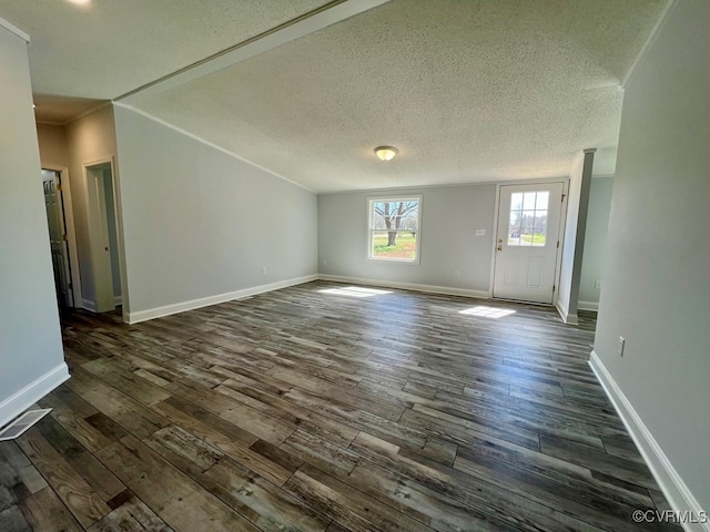 409 Remo Rd, Heathsville, VA 22473 - unfurnished living room featuring ornamental molding, dark wood-type flooring, baseboards, and a textured ceiling