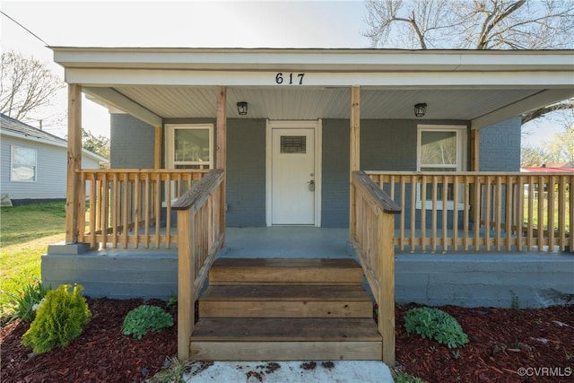 entrance to property featuring covered porch