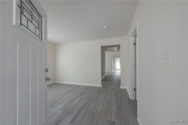 interior space featuring baseboards and wood finished floors
