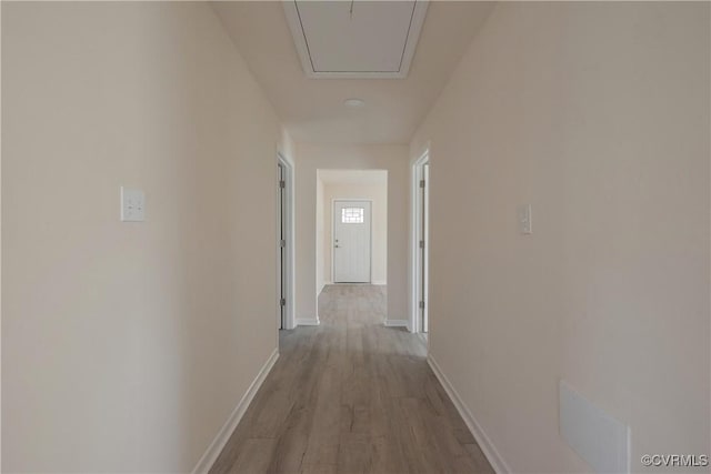 hallway with dark wood finished floors and baseboards