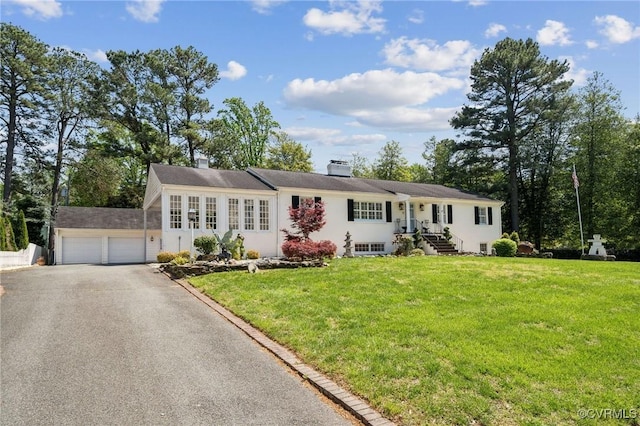 8203 Overbury Rd, Richmond, VA 23227 - view of front facade featuring a chimney, a front lawn, a garage, and stucco siding