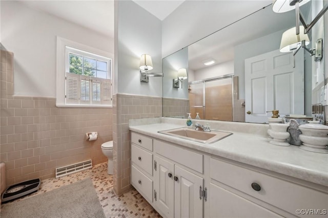 8203 Overbury Rd, Richmond, VA 23227 - bathroom featuring a wainscoted wall, toilet, visible vents, a shower stall, and vanity
