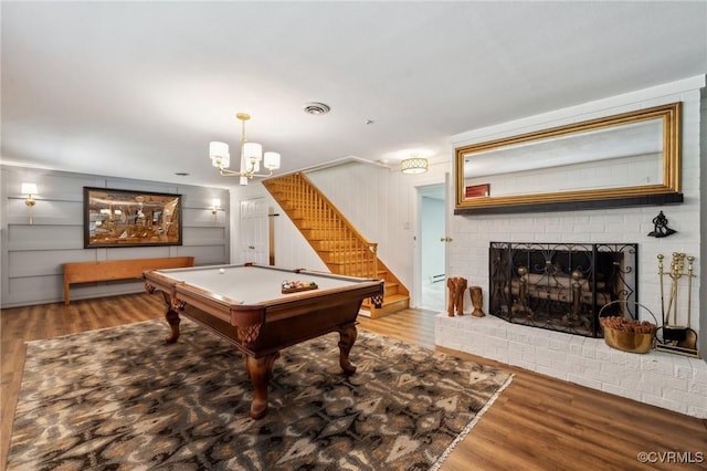 8203 Overbury Rd, Richmond, VA 23227 - playroom featuring an inviting chandelier, a brick fireplace, wood finished floors, and pool table
