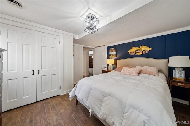8203 Overbury Rd, Richmond, VA 23227 - bedroom with a notable chandelier, wood finished floors, visible vents, and a closet