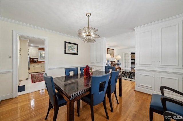 8203 Overbury Rd, Richmond, VA 23227 - dining space featuring crown molding, a chandelier, and light wood-style floors