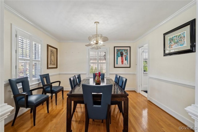 8203 Overbury Rd, Richmond, VA 23227 - dining room featuring light wood-style floors, crown molding, and an inviting chandelier