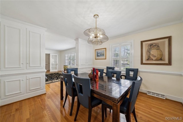 8203 Overbury Rd, Richmond, VA 23227 - dining space featuring light wood-type flooring, visible vents, an inviting chandelier, and crown molding