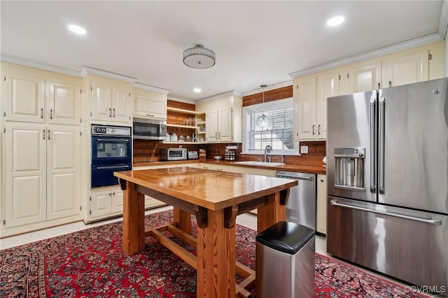 8203 Overbury Rd, Richmond, VA 23227 - kitchen featuring open shelves, butcher block countertops, a sink, stainless steel appliances, and recessed lighting