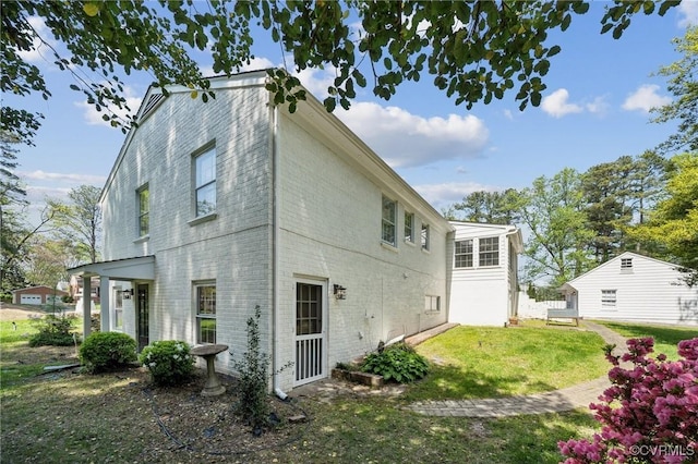 8203 Overbury Rd, Richmond, VA 23227 - back of house featuring brick siding and a yard