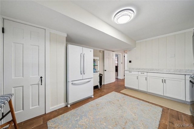 8203 Overbury Rd, Richmond, VA 23227 - kitchen with dark wood finished floors, white cabinetry, light stone countertops, and freestanding refrigerator