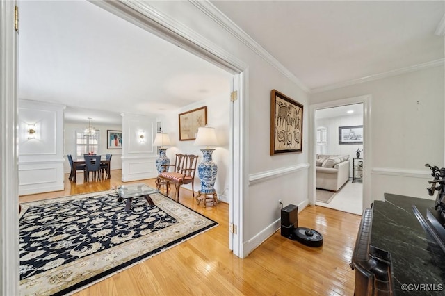 8203 Overbury Rd, Richmond, VA 23227 - corridor featuring light wood-style flooring, an inviting chandelier, and crown molding