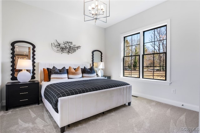 bedroom featuring a notable chandelier, light carpet, and baseboards