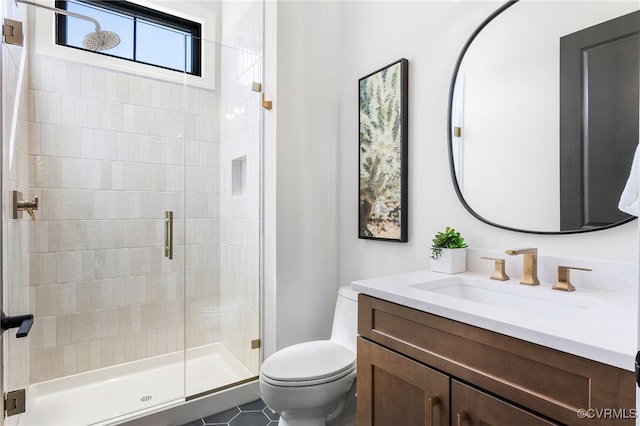 bathroom with vanity, toilet, and a shower stall