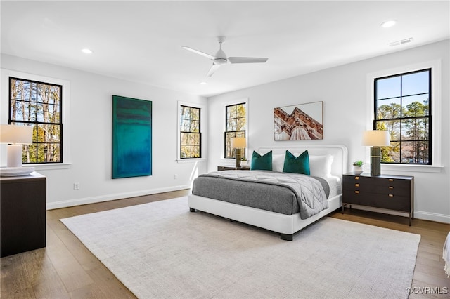 bedroom featuring wood finished floors, visible vents, and recessed lighting