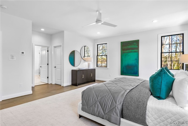 bedroom featuring baseboards, recessed lighting, wood finished floors, and ceiling fan
