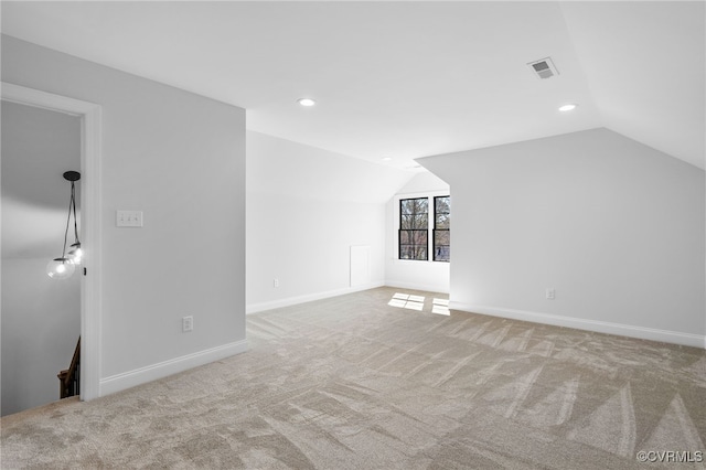 additional living space with visible vents, recessed lighting, carpet, and vaulted ceiling