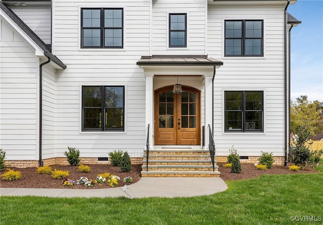 doorway to property with a lawn and crawl space