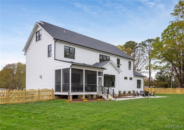 back of house with a fenced backyard, a shingled roof, a sunroom, a patio area, and a lawn