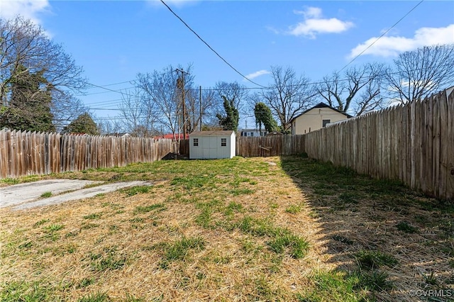 view of yard with a fenced backyard, a shed, and an outdoor structure