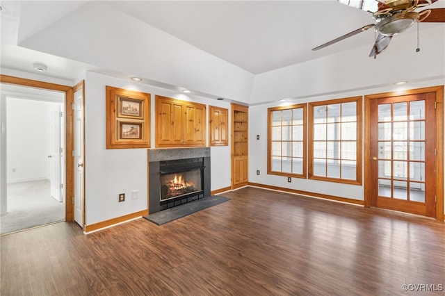 14007 Spring Rd, Montpelier, VA 23192 - unfurnished living room featuring a ceiling fan, dark wood-type flooring, baseboards, a warm lit fireplace, and baseboard heating