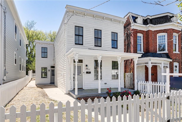 2205 Fairmount Ave, Richmond, VA 23223 - view of front of property with brick siding, covered porch, and a fenced front yard