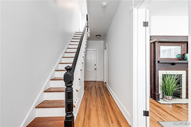 2205 Fairmount Ave, Richmond, VA 23223 - staircase with baseboards and wood finished floors