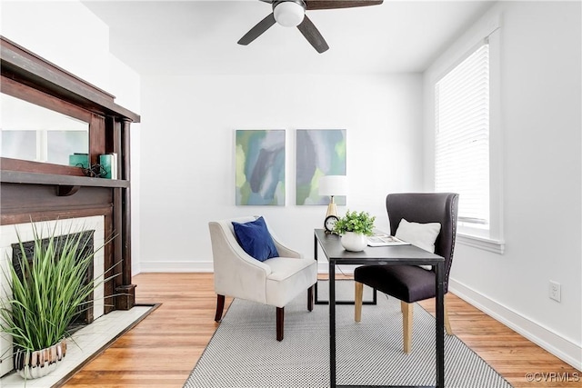 2205 Fairmount Ave, Richmond, VA 23223 - living area with light wood finished floors, a tile fireplace, baseboards, and a ceiling fan