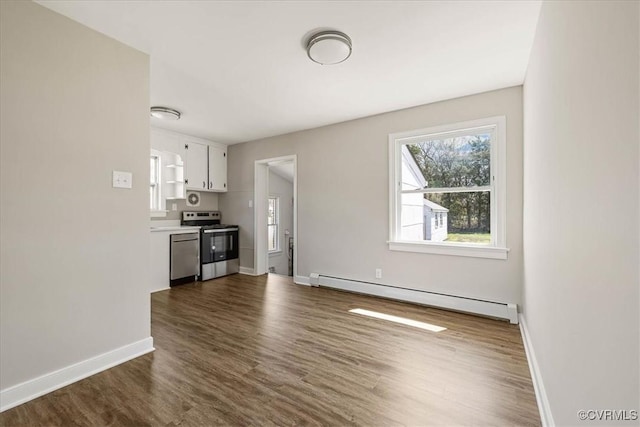 111 N Battery St, Highland Springs, VA 23075 - unfurnished living room featuring a baseboard heating unit, dark wood-type flooring, and baseboards