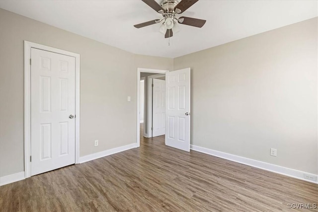 111 N Battery St, Highland Springs, VA 23075 - unfurnished bedroom featuring wood finished floors, baseboards, and a ceiling fan