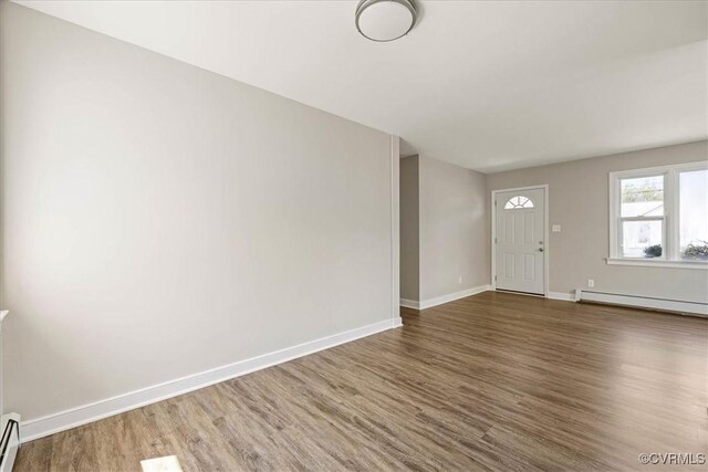 111 N Battery St, Highland Springs, VA 23075 - foyer entrance with baseboard heating, wood finished floors, and baseboards