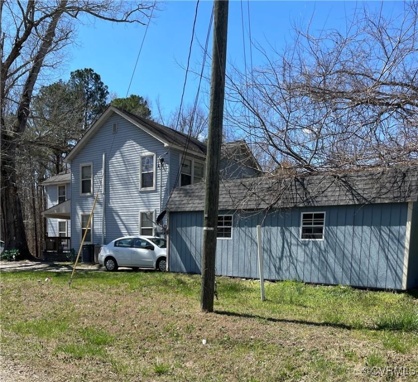 view of side of home with a lawn