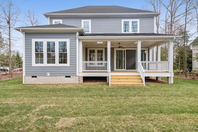 rear view of house featuring crawl space, a lawn, a porch, and a shingled roof