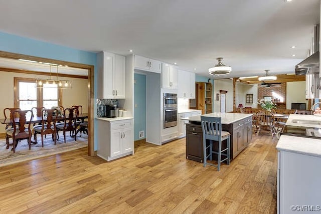 6920 Apamatica Ln, Chesterfield, VA 23838 - kitchen featuring double oven, white cabinets, light countertops, light wood-style floors, and recessed lighting