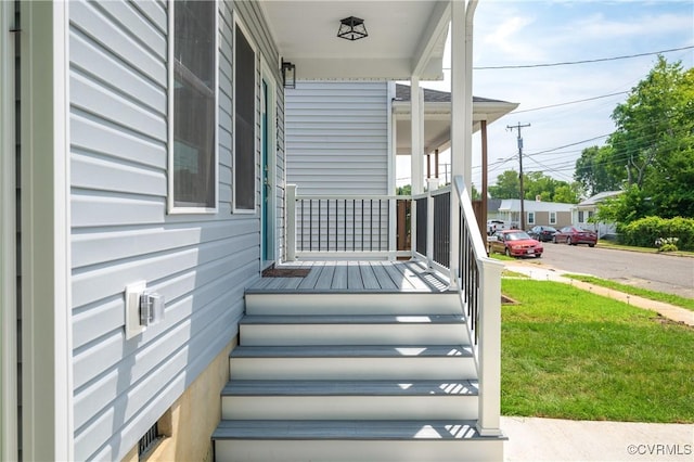 exterior space featuring a porch and a yard