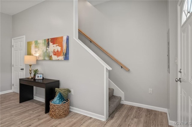 stairway featuring baseboards and wood finished floors