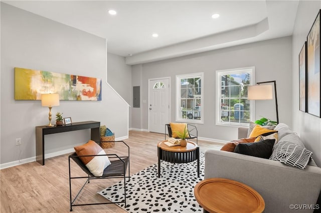 living room with light wood-style flooring, baseboards, and recessed lighting