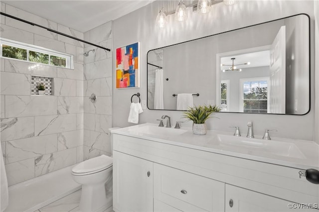full bath with a shower with curtain, double vanity, toilet, and a sink